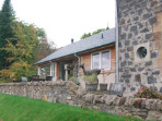 A new extension which takes advantage of the beautiful light and southerly view over the loch, and provides easy access to a partially roofed terrace.