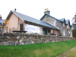 A new extension which takes advantage of the beautiful light and southerly view over the loch, and provides easy access to a partially roofed terrace.