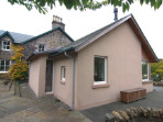 A new extension which takes advantage of the beautiful light and southerly view over the loch, and provides easy access to a partially roofed terrace.