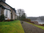 A new extension which takes advantage of the beautiful light and southerly view over the loch, and provides easy access to a partially roofed terrace.