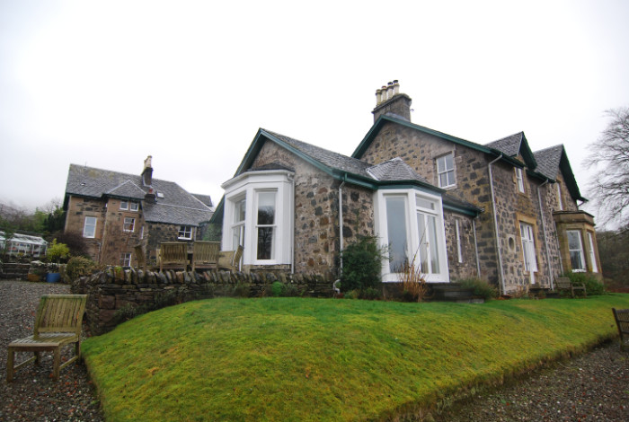 A new extension which takes advantage of the beautiful light and southerly view over the loch, and provides easy access to a partially roofed terrace.